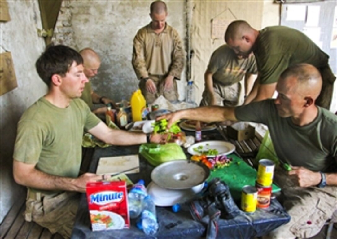 U.S. Marines prepare dinner on Patrol Base Jaker in Helmand province's Nawa district, Afghanistan, Aug 25, 2009. The Marines, assigned to the 1st Battalion, 5th Marine Regiment, Regimental Combat Team 3, are conducting counterinsurgency operations with Afghan forces in southern Afghanistan.