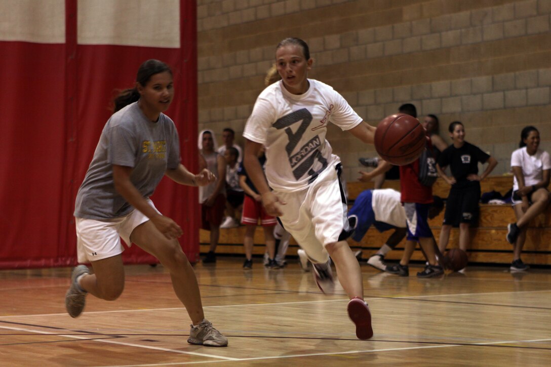 Amanda S. Shields, legal assistant, 1st Marine Logistics Group, dribbles past defender Ellena M. Compean, warehouse clerk, 1st Marine Division, during last year’s Marine Corps Community Services, Camp Pendleton 101 Days of Summer Sport Jam Series basketball tournament, Aug. 28. The 101 Days of Summer is a part of the MCCS’ Semper Fit Division’s Sports Jams Series. The three-part series is an effort to prevent drug and alcohol incidences among Camp Pendleton service members.