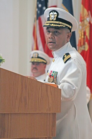 Cmdr. Cesar A. Odvina speaks after assuming the position of officer-in-charge of the Branch Health Clinic during a change-of-charge ceremony at the station chapel here Aug. 28.
