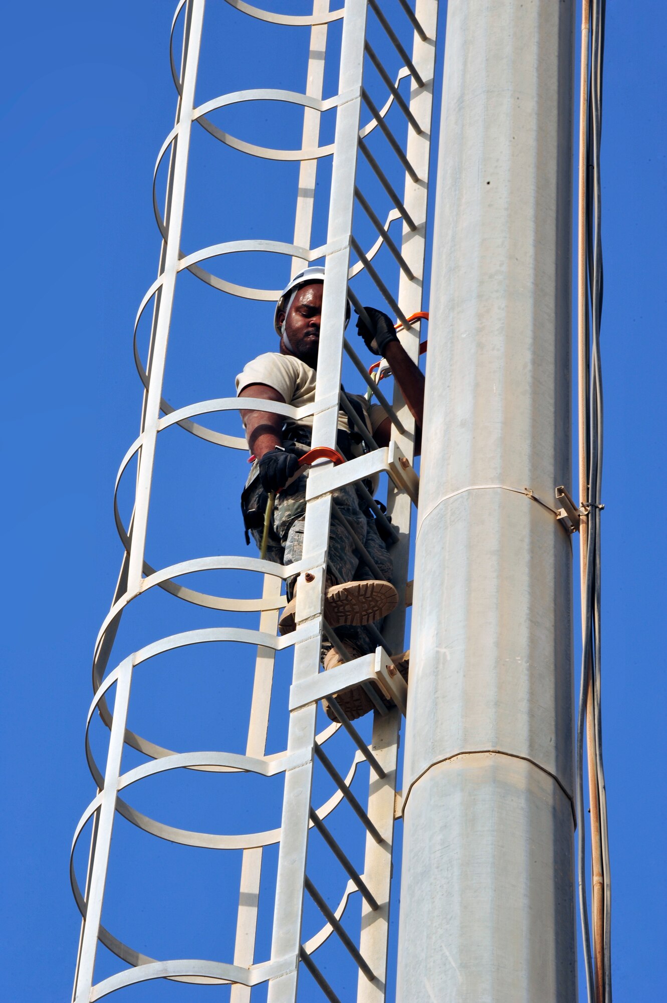 SOUTHWEST ASIA -Tech. Sgt. Antonio Turner, 380th Expeditionary Communication Squadron, climbs down from an equipment tower Aug. 26. Sergeant Turner is deployed from Lackland Air Force Base, Texas and hails from Richmond, Va. (U.S. Air Force photo/Tech. Sgt. Charles Larkin Sr)