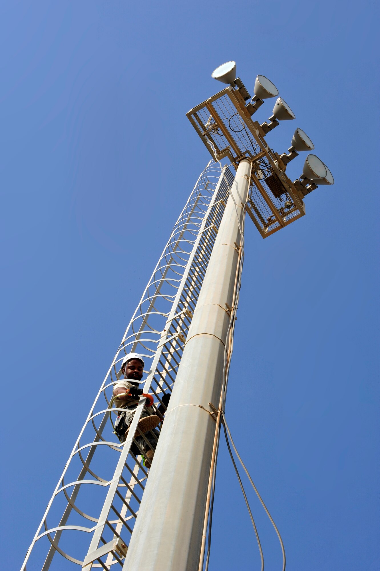 SOUTHWEST ASIA -Tech. Sgt. Antonio Turner, 380th Expeditionary Communication Squadron, climbs an 80 foot tower to clean communications equipment Aug. 26. Sergeant Turner is deployed from Lackland Air Force Base, Texas and hails from Richmond, Va. (U.S. Air Force photo/Tech. Sgt. Charles Larkin Sr)