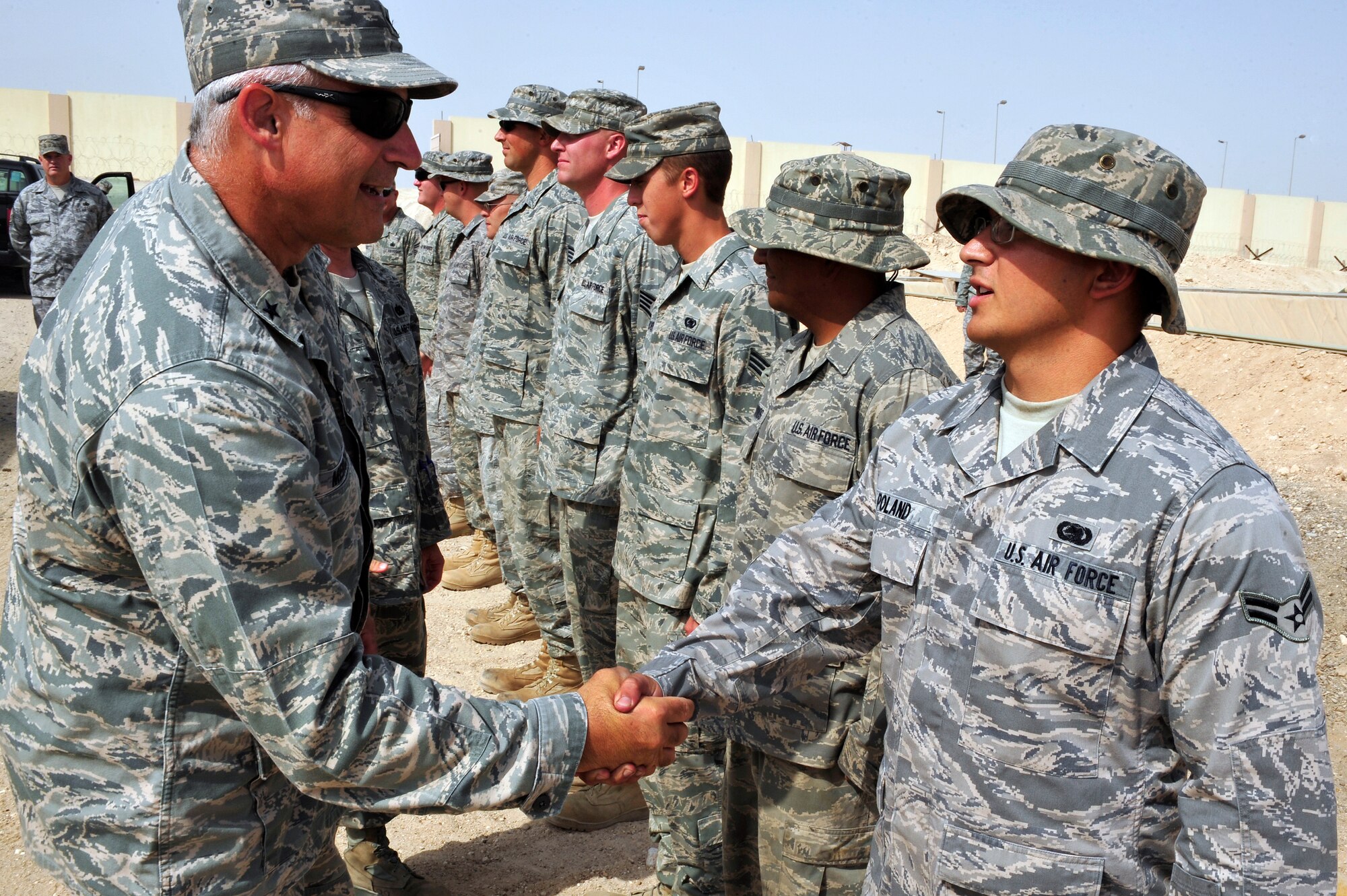 SOUTHWEST ASIA -Brig. Gen. Kenneth Merchant, Headquarters Air Mobility Command, Director of Logistics, greets members of the 380th Expeditionary Logistics Readiness Squadron during a tour of base facilities Aug. 28. General Merchent visited the 380th Air Expeditionary Wing to get a first-hand look at the wing operations. (U.S. Air Force photo/Tech. Sgt. Charles Larkin Sr)