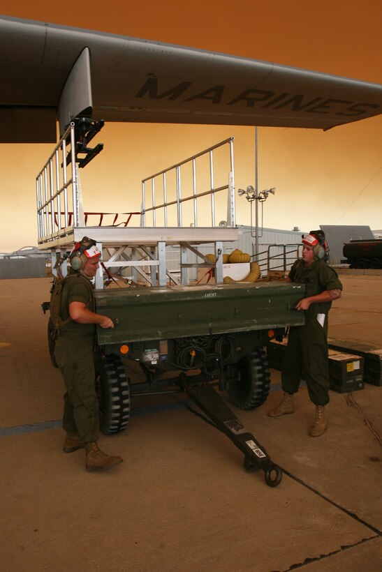 AIR FORCE PLANT 42, Calif. - Cpl. Sean W. Coleman and Lance Cpl. Jeremiah M. Poffenbarger, both ordnance technicians with Marine Aerial Refueler Transport Squadron 352 prepare to load Hellfire missiles onto a KC-130J "Super Hercules," carrying the new Harvest Hawk mission kit at Air Force Plant 42, Aug. 29. The squadron will train the aircrew and ordnance technicians when they receive the first Harvest Hawk mission kit in October.::r::::n::(Official U.S. Marine Corps photo by Cpl. Christopher O'Quin)(Released)