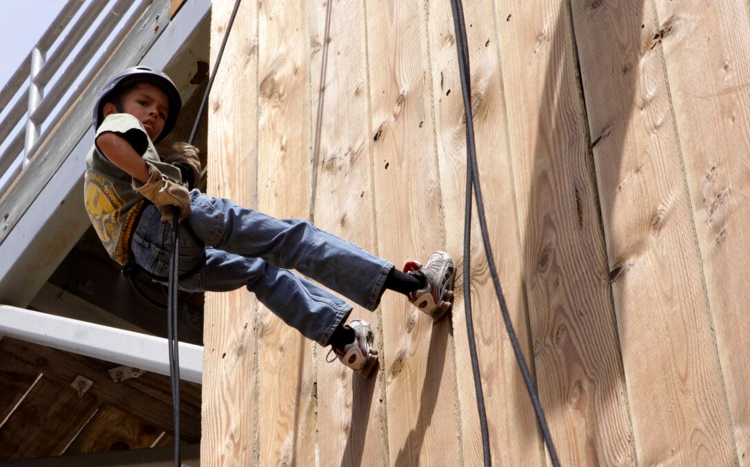 Recruit, Julian Brown, Eagle Young Marines, descends down a 60-foot-tall rappel tower located at Camp Horno, Camp Pendleton, Aug. 29.