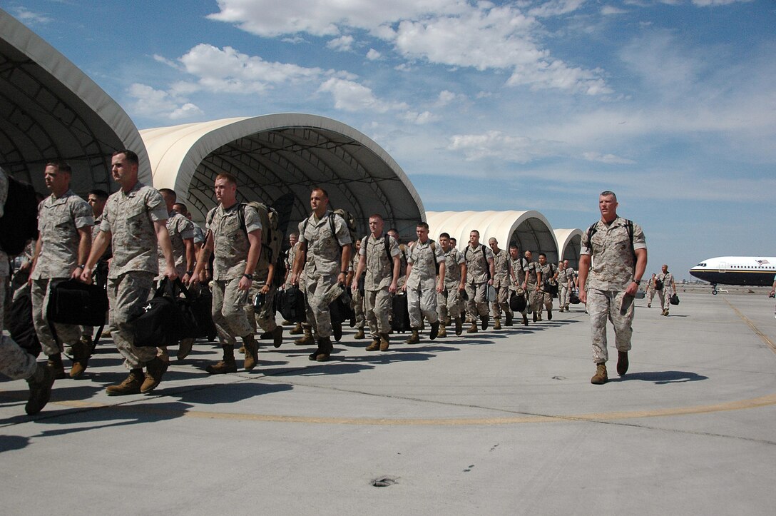 Marine Attack Squadron 211 and Marine Aviation Logistics Squadron 13 Marines march to VMA-211's hangar at the Marine Corps Air Station in Yuma, Ariz., Aug. 29, 2009, after a seven-month deployment aboard the USS Essex. The 80 Yuma Marines served with the 31st Marine Expeditionary Unit, providing offensive air support, reconnaissance and limited air defense during multinational training exercises.