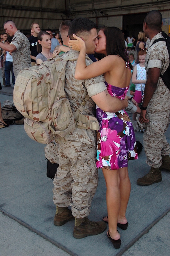 Lance Cpl. Ian Willoughby, Marine Aviation Logistics Squadron 13 avionics technician, kisses his wife, Laura, at hangar 101 at the Marine Corps Air Station in Yuma, Ariz., after returning home from a seven-month deployment Aug. 29, 2009. More than 20 MALS-13 Marines, along with approximately 60 Marine Attack Squadron 211 Marines, returned after serving aboard the USS Essex with the 31st Marine Expeditionary Unit. The MEU participated in several multinational training exercises, including Talisman Saber in Australia and Cobra Gold in Thailand.