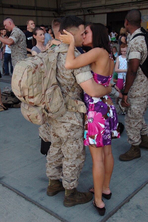 Lance Cpl. Ian Willoughby, Marine Aviation Logistics Squadron 13 avionics technician, kisses his wife, Laura, at hangar 101 at the Marine Corps Air Station in Yuma, Ariz., after returning home from a seven-month deployment Aug. 29, 2009. More than 20 MALS-13 Marines, along with approximately 60 Marine Attack Squadron 211 Marines, returned after serving aboard the USS Essex with the 31st Marine Expeditionary Unit. The MEU participated in several multinational training exercises, including Talisman Saber in Australia and Cobra Gold in Thailand.