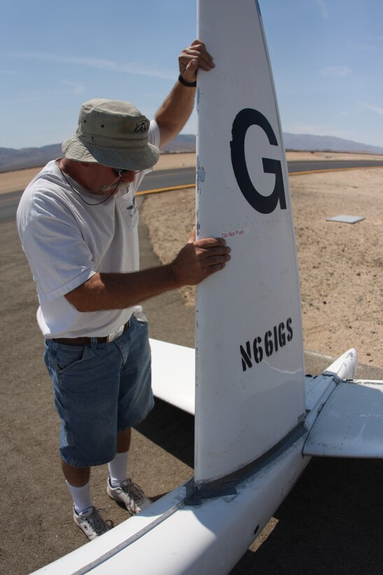 Ronald Renfro, the 29 Soaring Club president, checks the rudder on the back of his glider before taking off during the club's weekly gathering at the Twentynine Palms Airport Aug. 30.