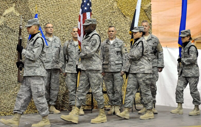 08/26/2009 -SATHER AIR BASE, Iraq, - The official party for the 447th Expeditionary Security Forces Squadron change-of-command ceremony stands by as the honor guard presents the colors here Aug. 26.  (U.S. Air Force photo / Staff Sgt. Misty D. Slater)


