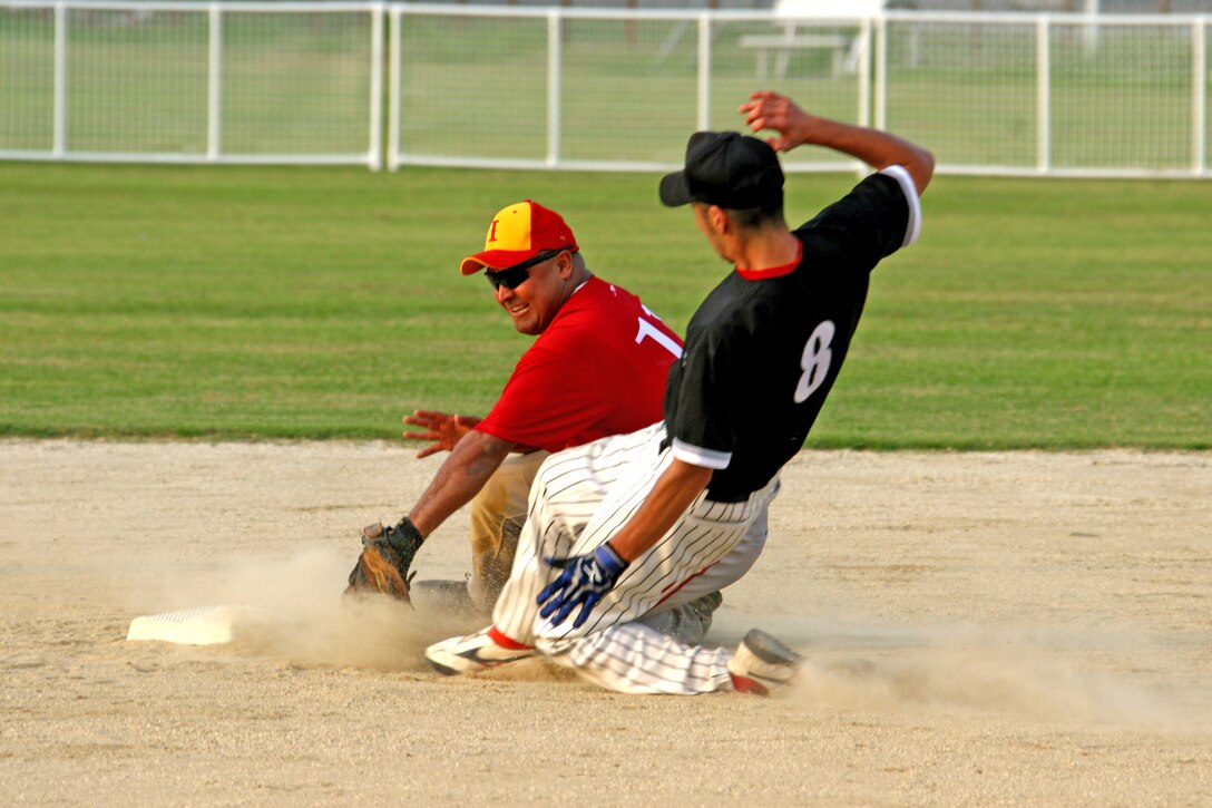 Team Iwakuni second baseman Rodney Buentello tags out a JelFix base runner just before the runner reaches the bag during the 2009 Japanese and American Modified Fast Pitch Softball Tournament held at Penny Lake softball fields here Aug. 29. Team Iwakuni posted a 6-0 record after beating JelFix of Hiroshima in the championship game 12 7.