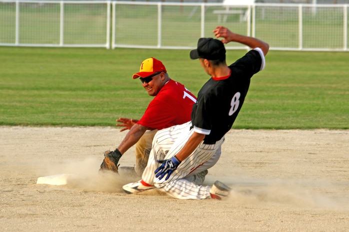 Team Iwakuni second baseman Rodney Buentello tags out a JelFix base runner just before the runner reaches the bag during the 2009 Japanese and American Modified Fast Pitch Softball Tournament held at Penny Lake softball fields here Aug. 29. Team Iwakuni posted a 6-0 record after beating JelFix of Hiroshima in the championship game 12 7.