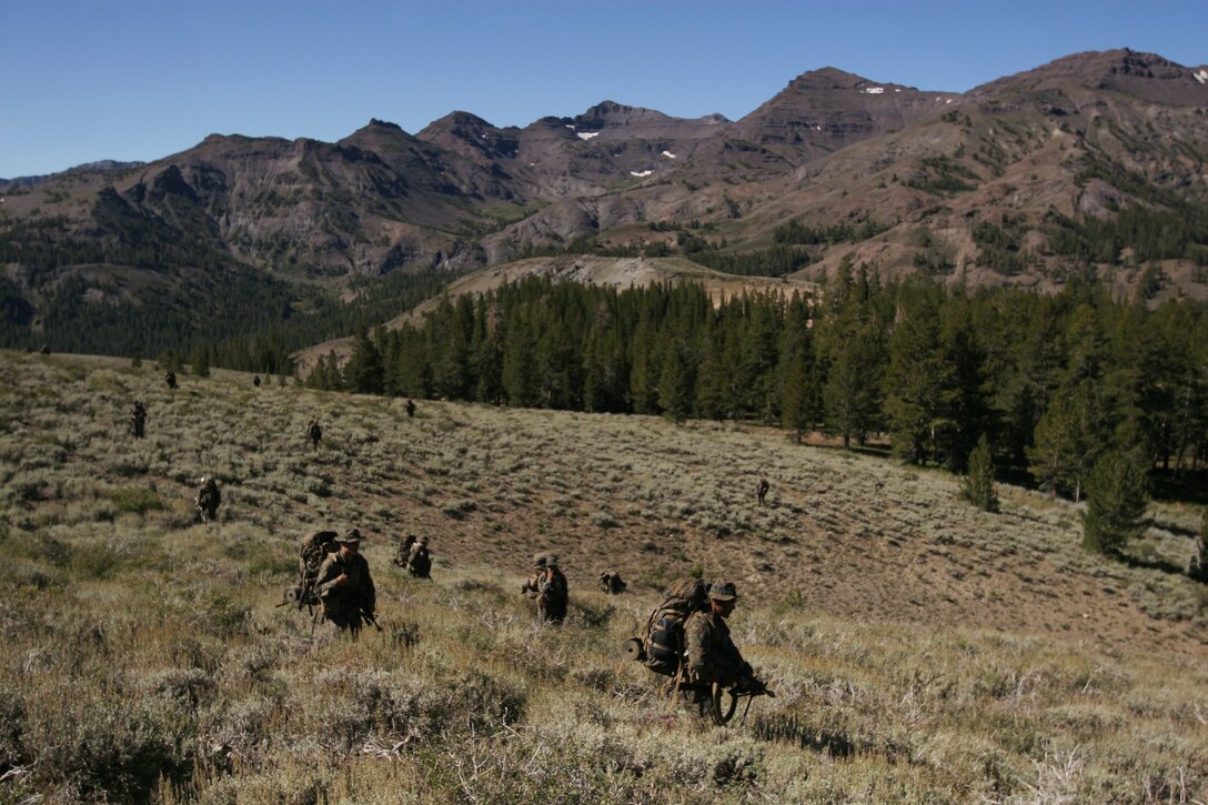 MARINE CORPS MOUNTAIN WARFARE TRAINING CENTER BRIDGEPORT, Calif. – Marines with Company K, 3rd Battalion, 7th Marine Regiment, patrol the hills near Landing Zone Penguin here Aug. 31. The company patrolled and marched several miles during their three-week training exercise aboard the training center.