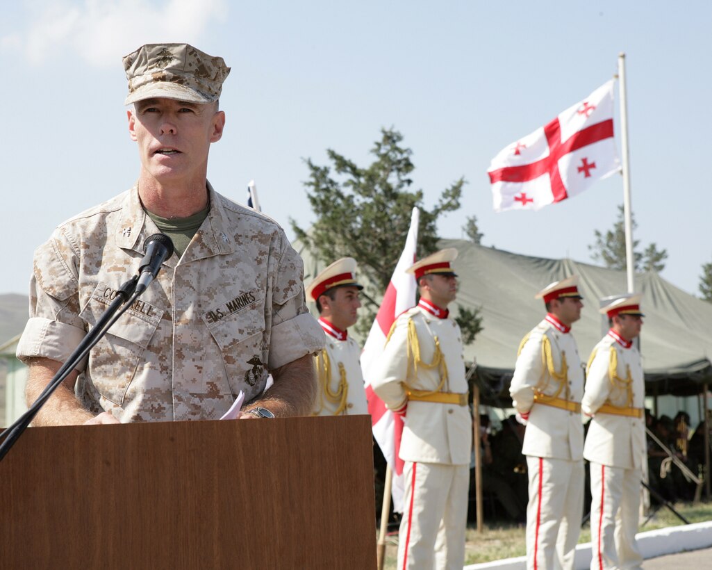 090831-M-6023F-001::r::::n::TBISILI (Aug. 31, 2009)—Col. Scott C. Cottrell, director, Marine Corps Training and Advisory Group, speaks to a formation of U.S. Marines and Georgian soldiers during the opening ceremony of the Georgia Deployment Program at the Krtsanisi National Training Center. Members of MCTAG, along with instructors from various units throughout the Marine Corps, are here to train Georgia’s 3rd Brigade, 31st Light Infantry Battalion for their upcoming deployment. The Georgia Deployment Program is a two-year training program with a goal to increase interoperability between the Georgian Army and International Security Assistance Forces (ISAF). The training consists of four 6-month rotations designed to train four Georgian infantry battalions in counter-insurgency tactics, techniques and procedures in preparation for their deployment to Afghanistan in support of ISAF. (U.S. Marine Corps photo by Master Sgt. Grady T. Fontana)::r::::n::