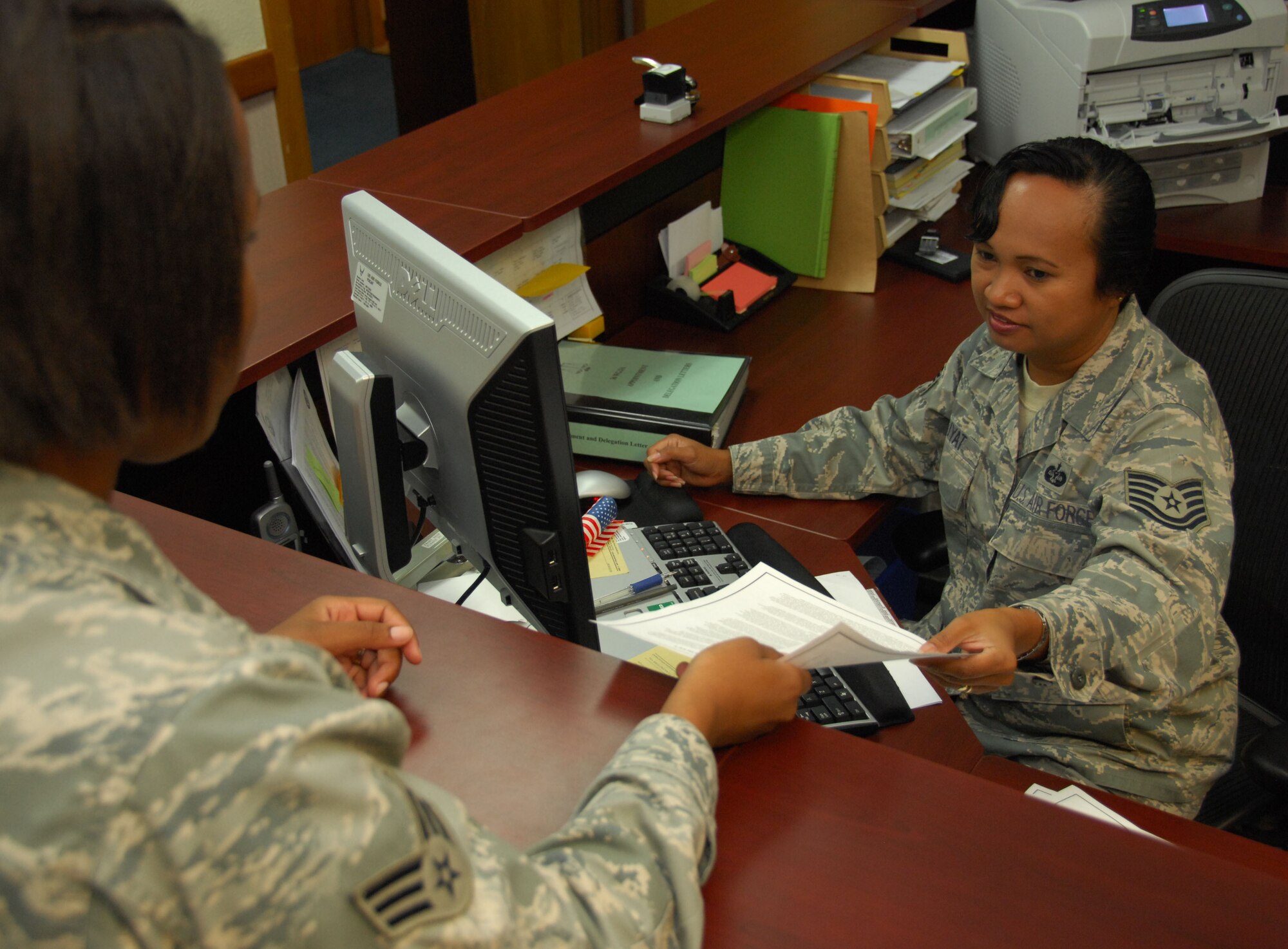 ANDERSEN AIR FORCE BASE, Guam - Tech. Sgt. Elaine Suyat (right), noncommissioned officer in charge of claims for the 36th Wing legal officers, assists an Airman with a general power of attorney here Aug. 28. The legal office provides a variety of services in order to meet the legal needs of all active duty and reserve military members, civilians, dependents and retirees in the Andersen community. (U.S. Air Force photo by Senior Airman Shane Dunaway)