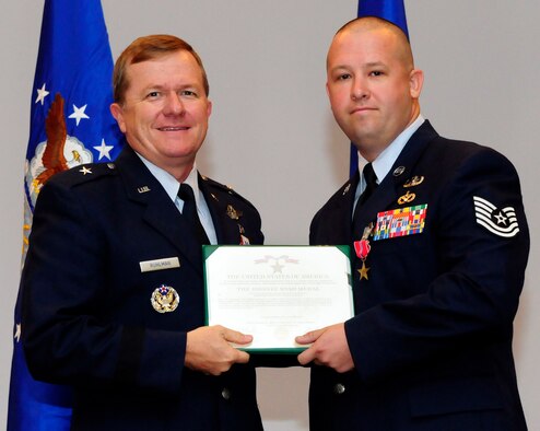 ANDERSEN AIR FORCE BASE, Guam - Tech Sgt. Mark Brady, 36th Civil Engineer Squadron, receives the Bronze Star from Brig. Gen. Phil Ruhlman, 36th Wing commander, during the end of the month promotion ceremony here Aug 28.
Sergeant Brady served as an explosive ordnance disposal team leader for the 332nd Expeditionary Civil Engineer Squadron at Joint Base Balad, Iraq. (U.S. Air Force photo by Airman 1st Class Courtney Witt)
