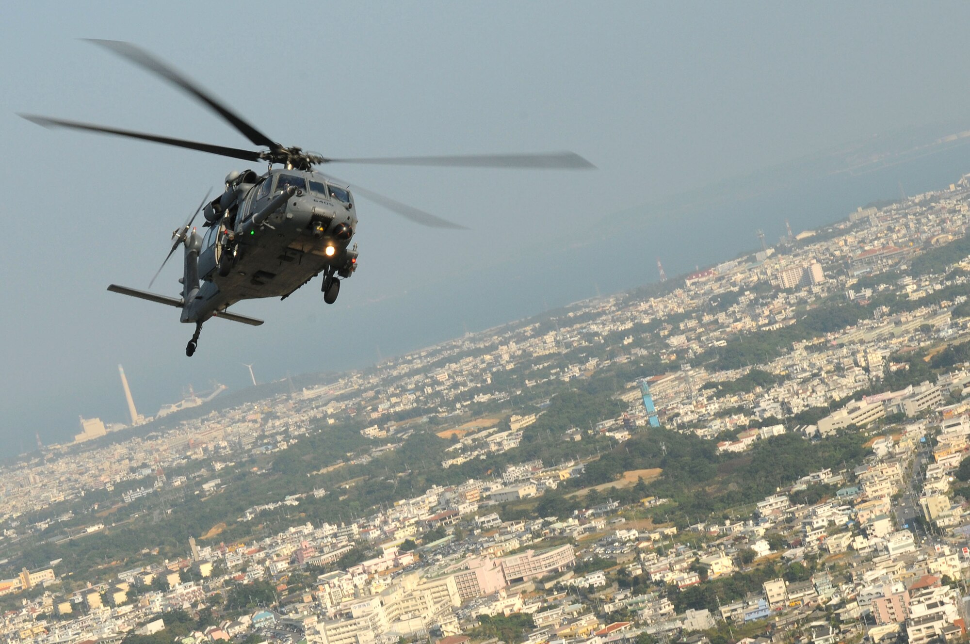 An HH-60 Pave Hawk  from the 33rd Rescue Squadron at Kadena Air Base, flies over Okinawa, after an air refueling mission off the coast of Okinawa, Japan as part of exercise Cope Angel 09-1. Cope Angel is a joint rescue exercise between members of the U.S. Air Force and the Japanese Air Self Defense Force. (U.S. Air Force photo/Staff Sgt Chrissy Best)
