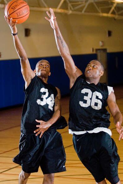 KUNSAN AIR BASE, Republic of Korea -- Robert Carter, 8th Force Support Squadron, goes for a layup against Cedric Monroe, 8th Logistics Readiness Squadron, during tryouts for the men's varsity basketball team here Aug. 27. Twenty Airmen competed for a spot on the team so they could compete against other bases throughout the Republic of Korea. (U.S. Air Force photo/Senior Airman Jonathan Steffen)