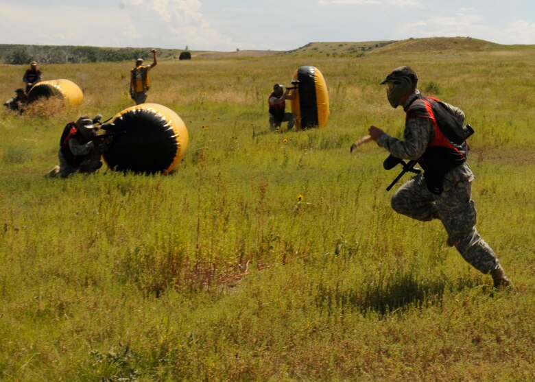 Soldiers from the 100th Missile Defense Brigade (Ground-based Midcourse Defense) lay down suppressive fire in the distance as a fire team member bounds backwards during a training event on Fort Carson, Colo. (Army photo by Chief Warrant Officer 2 Anita Thompson)