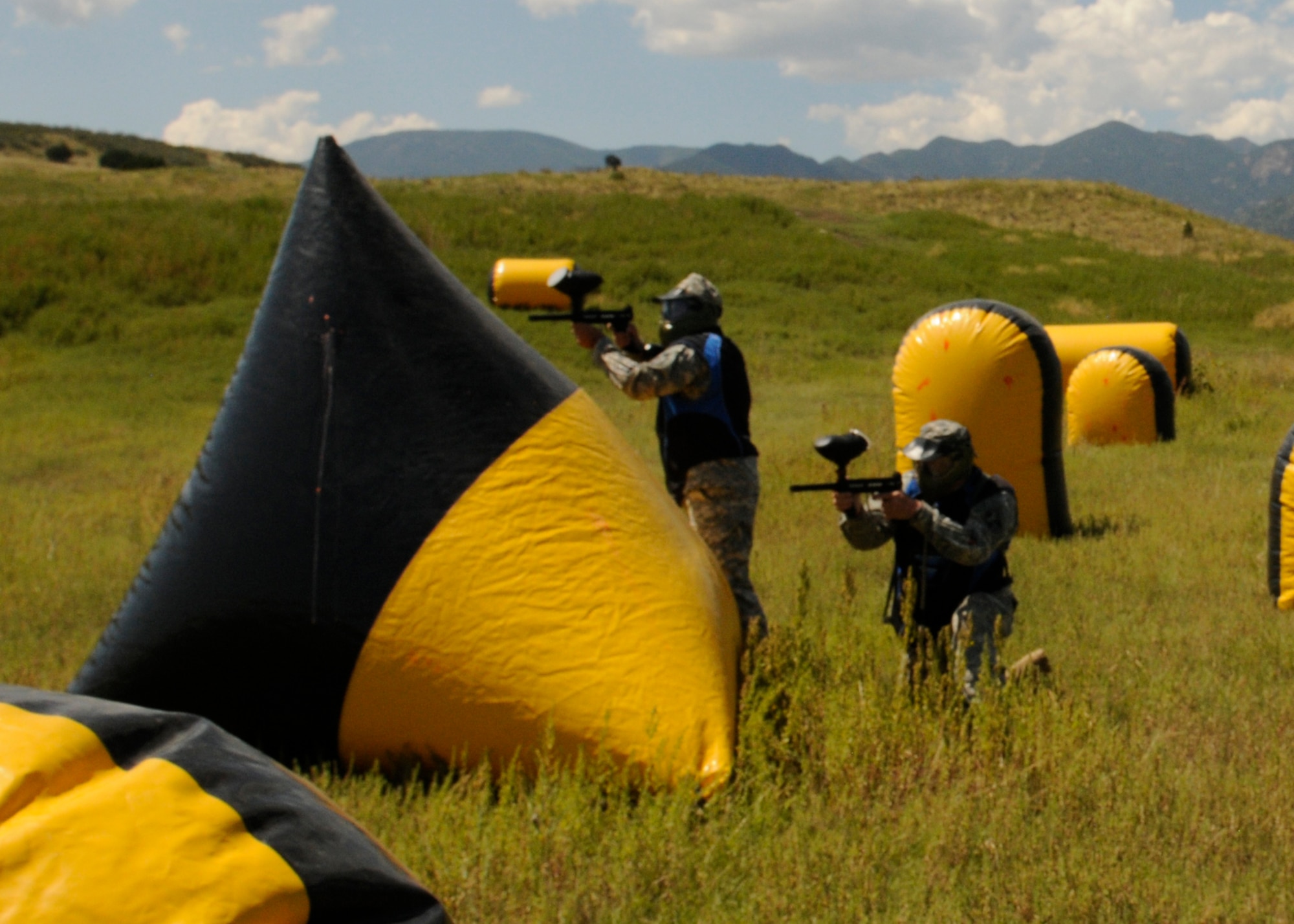 Soldiers from the 100th Missile Defense Brigade (Ground-based Midcourse Defense) take cover behind an inflatable obstacle during react to contact training using paintballs on Fort Carson, Colo. (Army photo by Chief Warrant Officer 2 Anita Thompson)