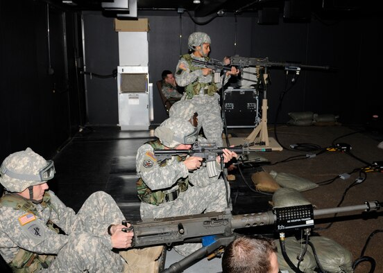 Soldiers from the 100th Missile Defense Brigade (Ground-based Midcourse Defense) utilize the Engagement Skills Trainer 2000 for weapons familiarization on Fort Carson, Colo. The EST 2000 works by connecting air hoses driven by a compressor and laser beams to simulate bullet trajectory and can simulate dozens of different scenarios in virtual combat. (Army photo by Sgt. Joseph Ten Eyck)