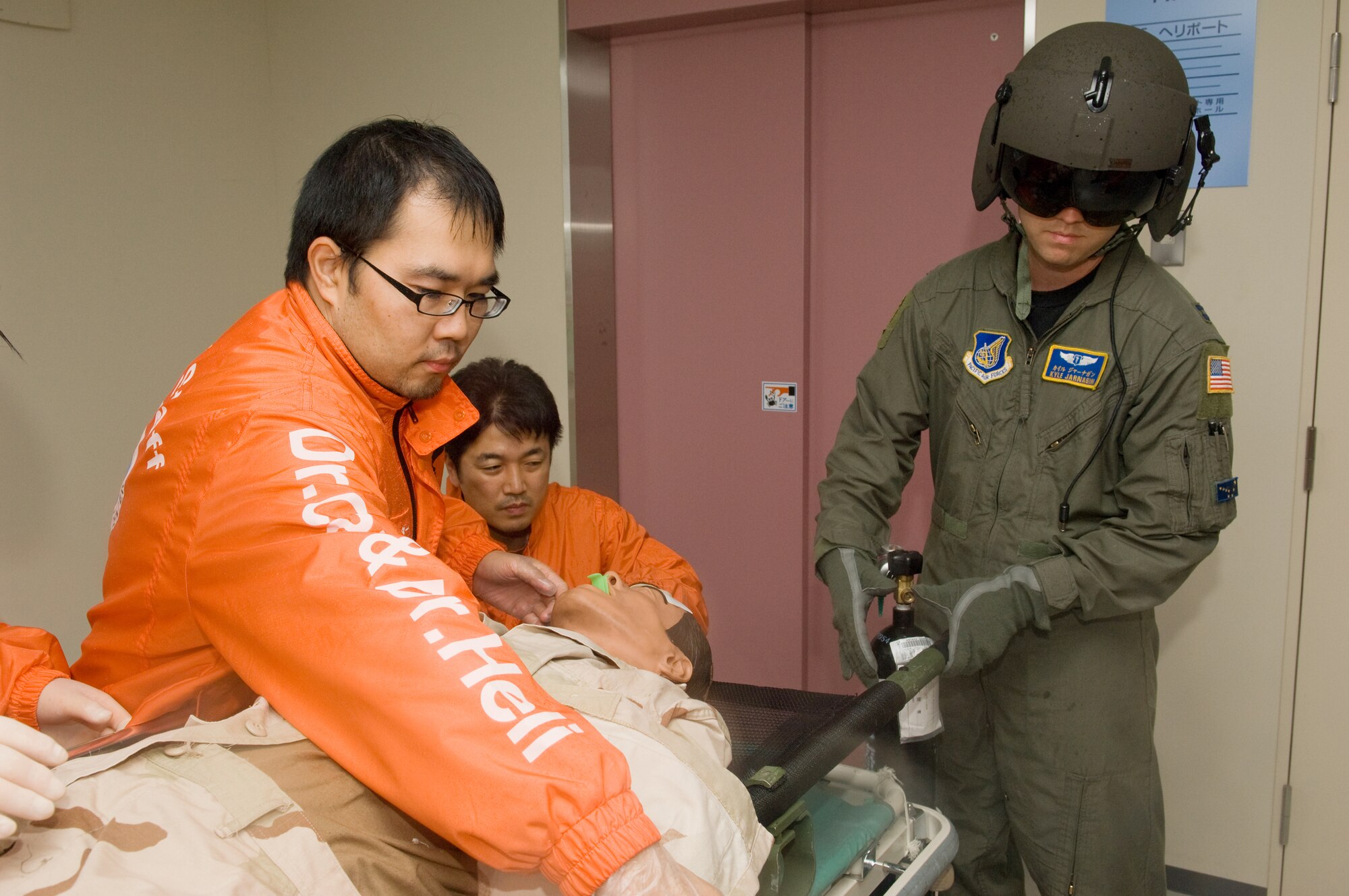 TACHIKAWA, Japan -- Capt. Kyle Jarnagin, 374th Medical Group flight surgeon, delivers a simulated patient to personnel at the National Disaster Medical Center in Tachikawa Aug. 30 during a Tokyo Metropolitan Government Comprehensive Disaster Prevention Drill. U.S. forces in the Pacific have a strong disaster response record in the region. Yokota Airmen delivered 18,000 pounds of supplies to Japanese response teams after an earthquake in Niigata Prefecture in 2004, and U.S. servicemembers delivered nearly 5,000 tons of relief supplies and treated more than 2,200 patients in Southeast Asia after the devastating tsunami the same year. (U.S. Air Force photo/Osakabe Yasuo)
