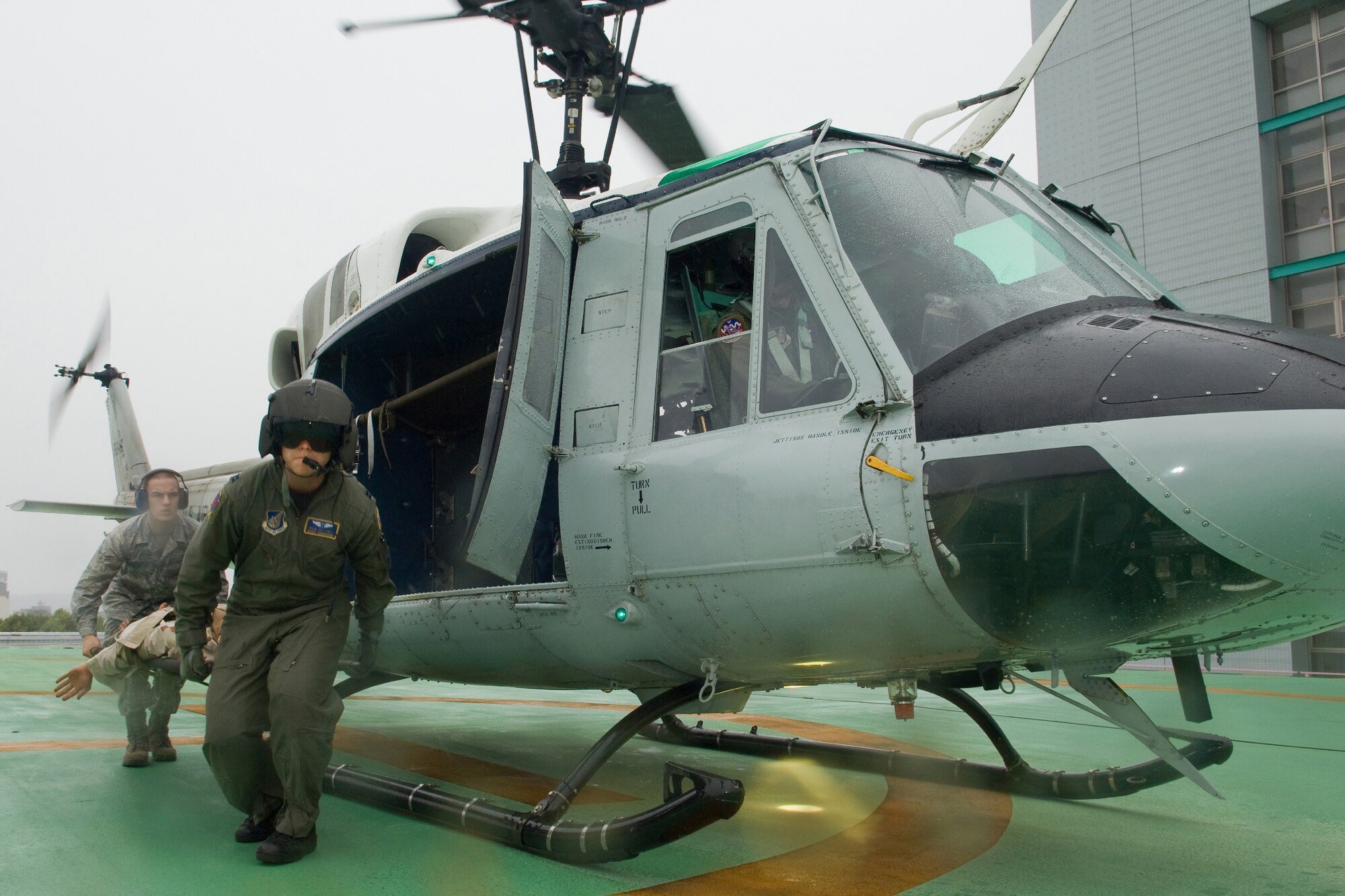 TACHIKAWA, Japan -- Capt. Kyle Jarnagin, 374th Medical Group flight surgeon, (foreground)  and Airman 1st Class Gary Held, 374th MDG,  transport a simulated patient from a UH-1N Huey from the 459th Airlift Squadron at Yokota Air Base, to the National Disaster Medical Center in Tachikawa Aug. 30 during a Tokyo Metropolitan Government Comprehensive Disaster Prevention Drill.  Yokota personnel practiced delivering medical supplies via helicopter to a Japan Self-Defense Forces hospital  and transporting a patient from the hospital to the medical center in Tachikawa. (U.S. Air Force photo/Osakabe Yasuo)
