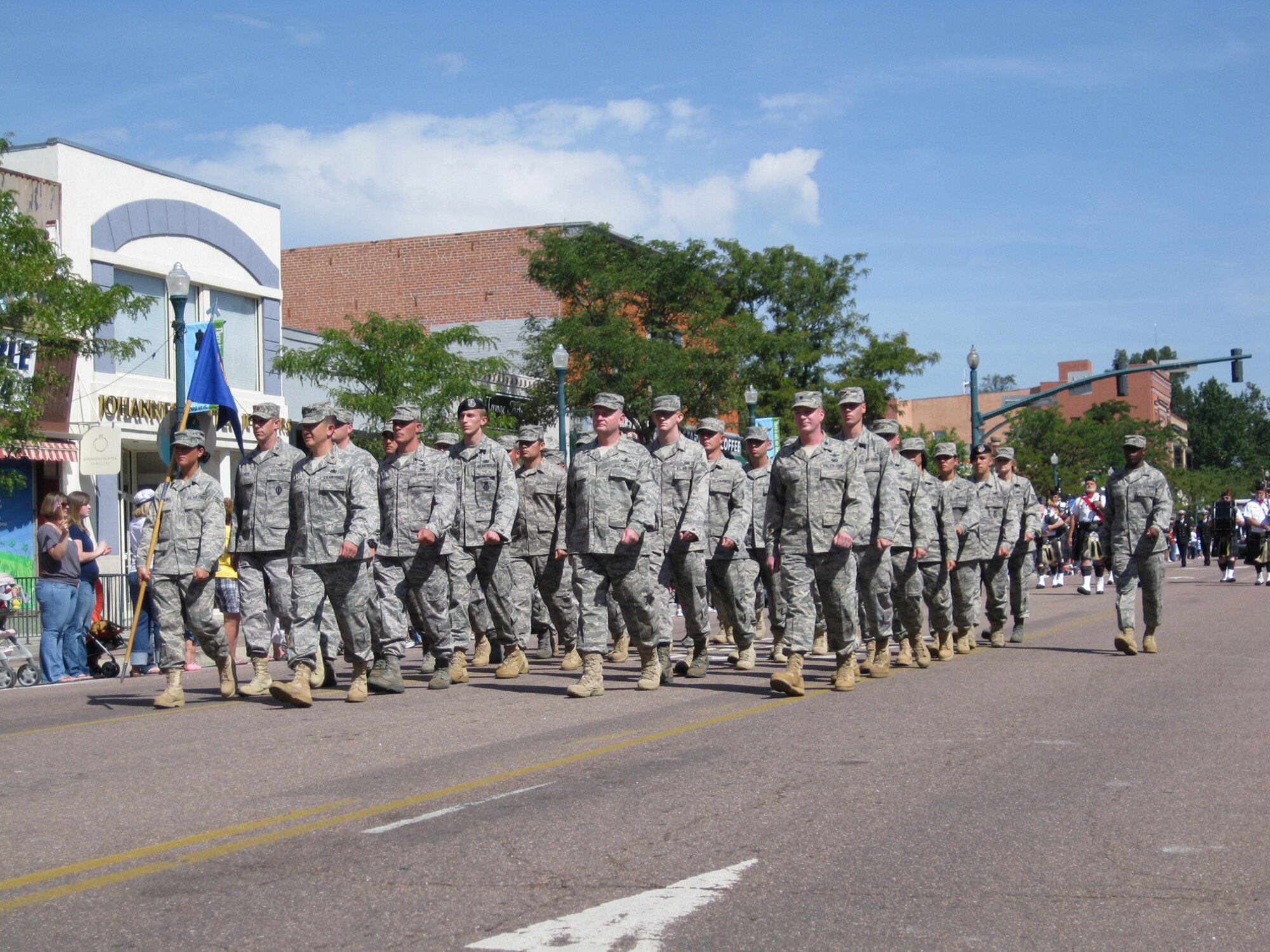 Airmen from the 21st Space Wing marched in the Red, White and Brave parade Aug. 29 in Colorado Springs. The 21st SW flight represented the more than 800 warrior Airmen the wing deploys each year. About 3,500 servicemembers marched through the heart of downtown to the appreciative cheers of an estimated 45,000 spectators, who also enjoyed vintage military aircraft flyovers, bands and other entertaining entries. (Air Force photo by Steve Brady)