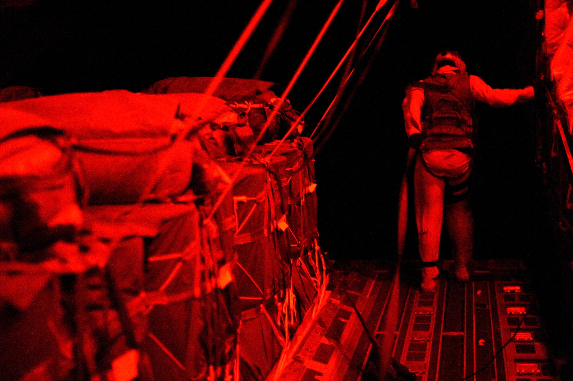 Senior Airman Bryce Kester looks out the ramp of a C-17 Globemaster III during a supply airdrop for a forward operating base in Afghanistan, Aug. 27, 2009, in support of Operation Enduring Freedom.  Airman Kester is a loadmaster from the 817th Expeditionary Airlift Squadron, and deployed from McChord Air Force Base, Wash.  (U.S. Air Force photo/Staff Sgt. Michael B. Keller)