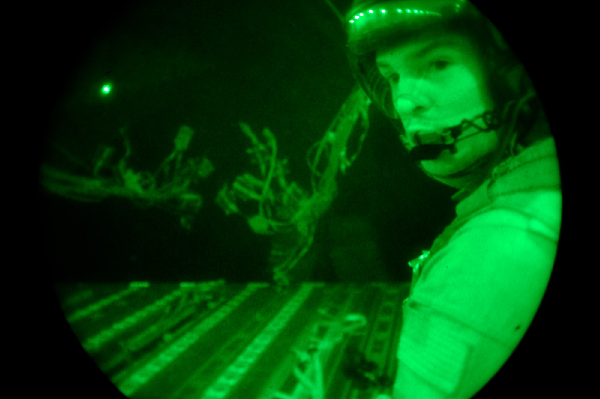 Senior Airman Bryce Kester monitors supplies being dropped from a C-17 Globemaster III to a forward operating base in Afghanistan, Aug. 27, 2009.  Airman Kester is deployed from McChord Air Force Base, Wash.  (U.S. Air Force photo/Staff Sgt. Michael B. Keller)
