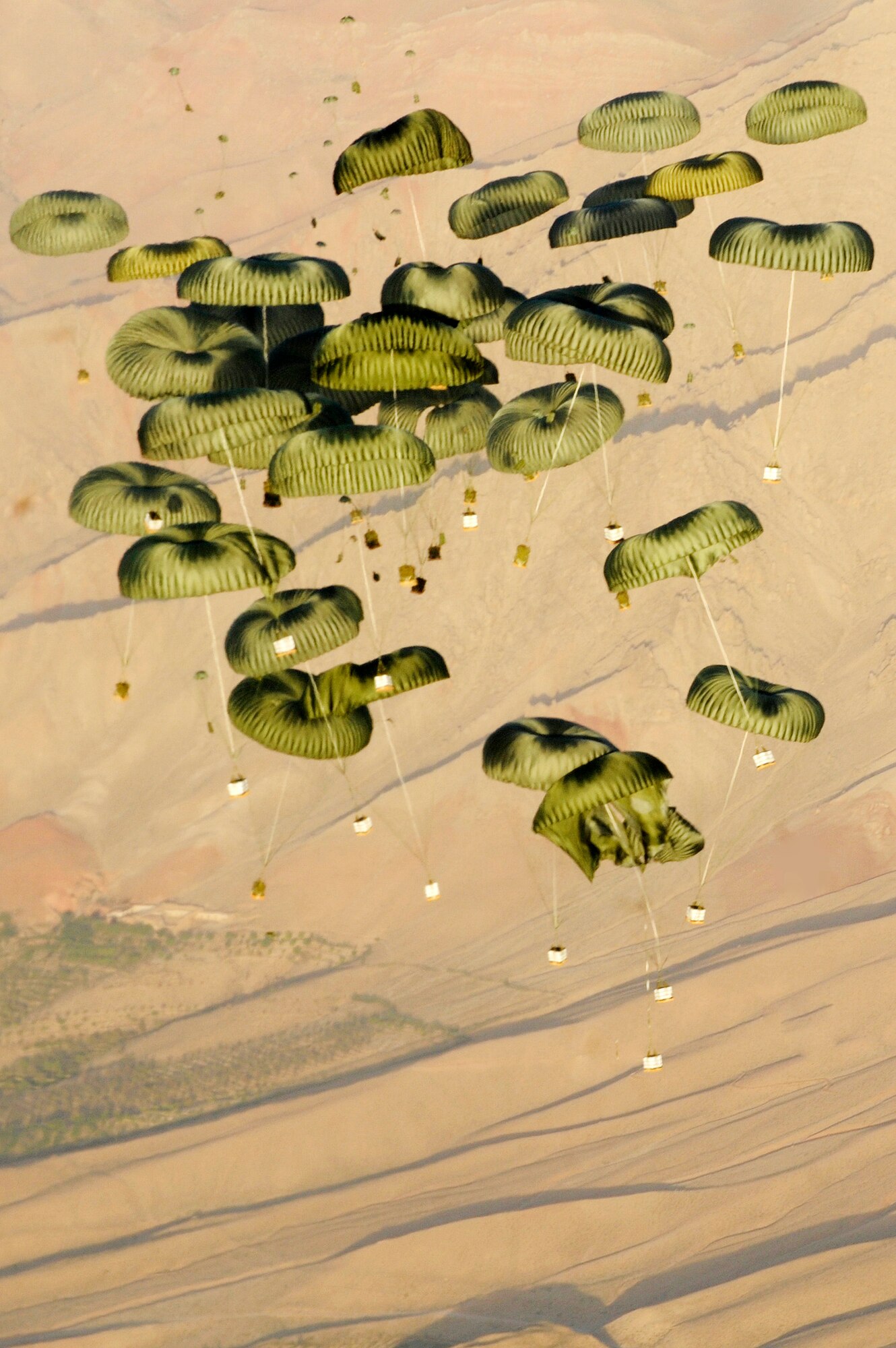 Pallets of cargo drop from a C-17 Globemaster III to a forward operating base in Afghanistan, Aug. 27, 2009, in support of Operation Enduring Freedom.  The aircraft is assigned to the 817th Expeditionary Airlift Squadron. (U.S. Air Force photo/Staff Sgt. Michael B. Keller)