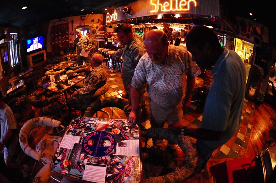 DYESS AIR FORCE BASE, Texas -- James Nicholas, club manager, and Zel McGhee, Dyess Community Center director, looked at the table and chairs that were presented to the Bomb Shelter here Aug. 28 by the 317 AMXS Top 3. The 317 AMXS hopes other squadrons follow their lead and help make the Bomb Shelter a better place for enlisted Airmen. (U.S. Air Force Photo by Airman 1st Class Stephen Reyes)