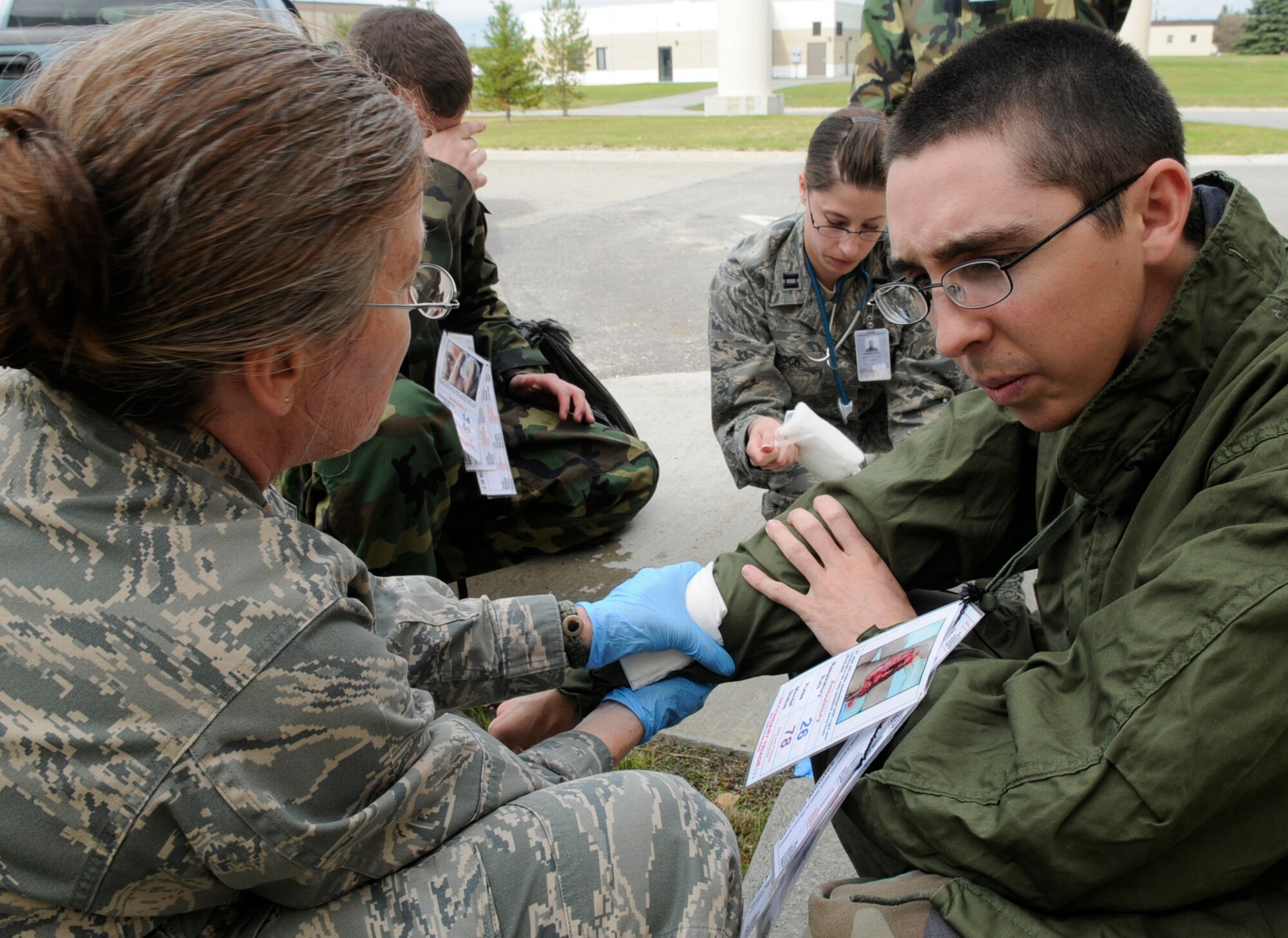Maj. Karen Kirk provides first aid for a simulated injured Airmen during an emergency management exercise Aug. 26, 2009, at Eielson Air Force Base, Alaska. The exercise simulated a hazardous material exposure to test the capabilities of the base's health care and surrounding community's emergency response professionals. Major Kirk is assigned to the 354th Medical Group. (U.S. Air Force photo/Airman 1st Class Laura Goodgame)