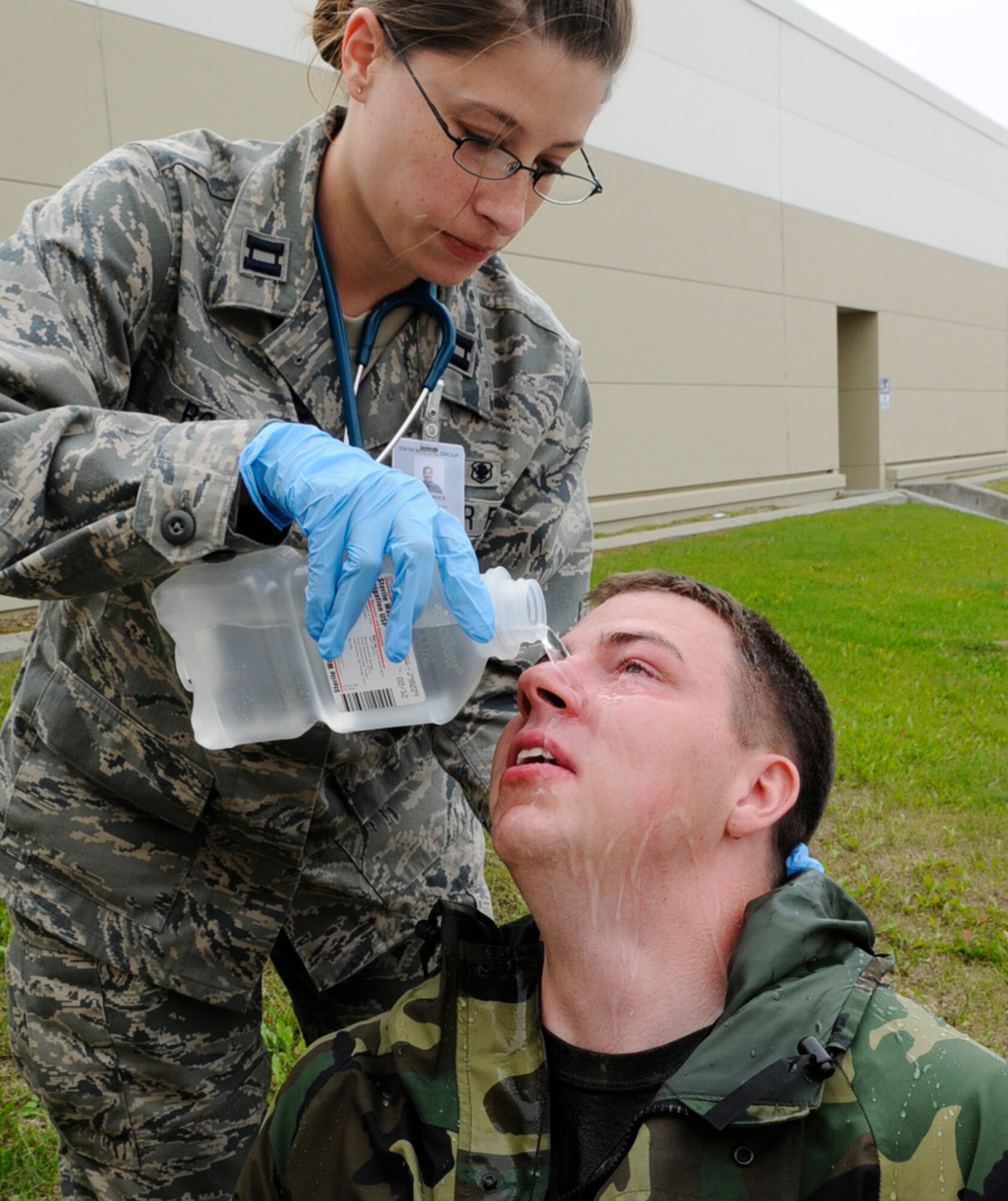 Capt. Jennifer Rock flushes an Airman's eyes during an emergency management exercise Aug. 26, 2009, at Eielson Air Force Base, Alaska. The exercise tested emergency response team member's skills to handle incidents on base.  Captain Rock is assigned to the 354th Medical Group. (U.S. Air Force photo/Airman 1st Class Laura Goodgame)
