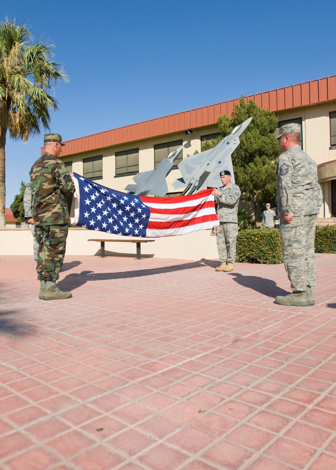 Senior Noncommissioned Officers hold a retreat ceremony at the flag pole in front of the Air Force Flight Test Center Headquarters building here Aug. 28. The retreat was held as Edwards monthly retreat ceremony for August. (Air Force photo/Heather Anhalt)