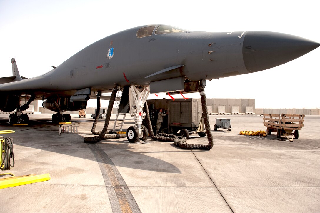 Tech. Sgt. Jesse Maddox installs a splitter on an air conditioner unit Aug. 26 at an undisclosed location in Southwest Asia. Sergeant Maddox, along with his co-workers, designed and manufactured a custom splitter that limits the number of air conditioning units supporting a B-1B Lancer from multiple units down to a single unit. Sergeant Maddox is a 379th Expeditionary Maintenance Squadron metals technology floor supervisor and is deployed from Ellsworth Air Force Base, S.D. (U.S. Air Force photo/Staff Sgt. Robert Barney)
