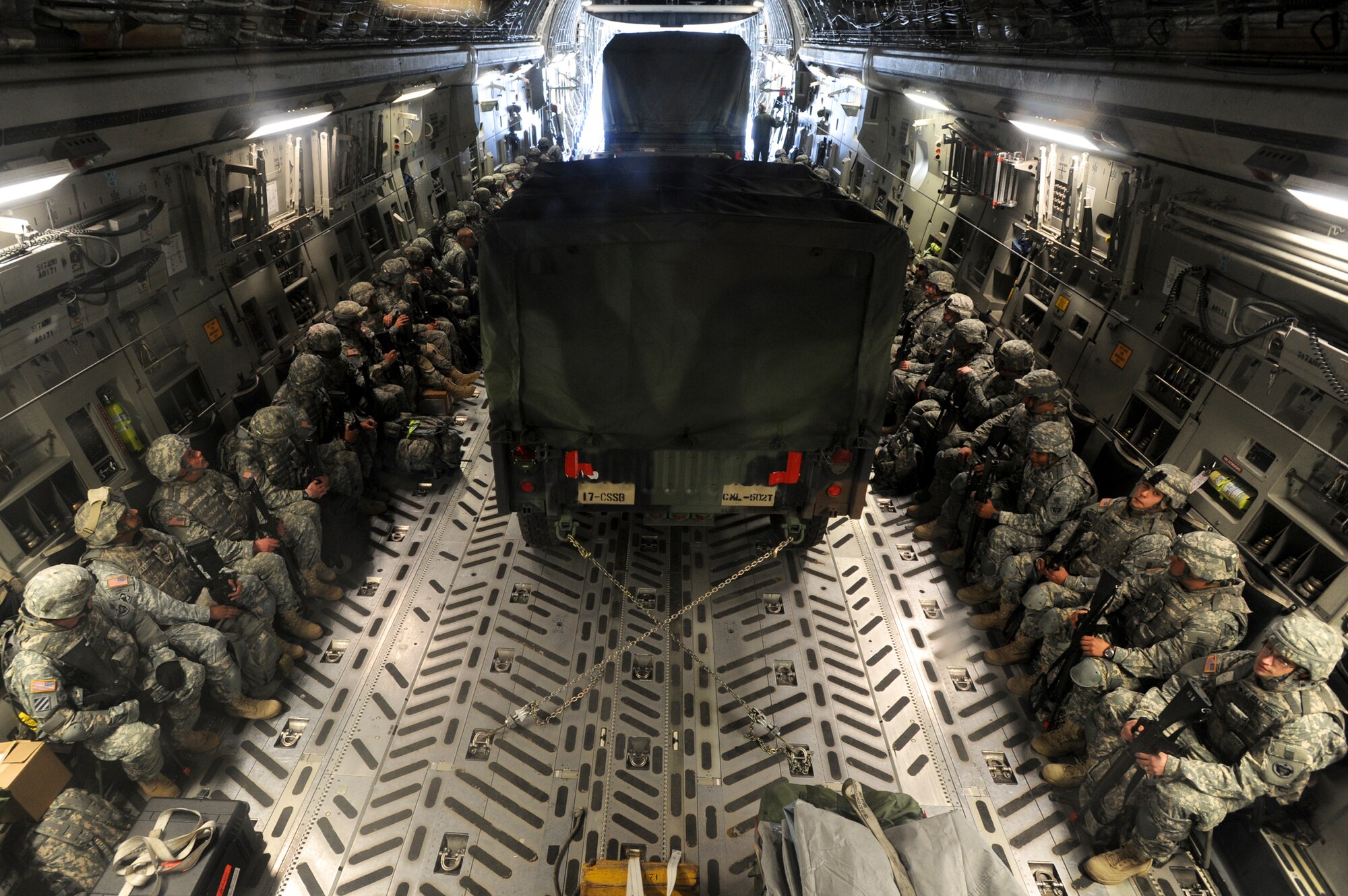 Members from the 17th Combat Service Support Battalion out of Fort Richardson, Alaska, wait on board a C-17 Globemaster III before take off Aug. 24 at Elmendorf Air Force Base, Alaska. Operation Arctic Response is a joint operation and total force integration exercise where Air Force active-duty and National Guard members aid the Army in deploying to the exercise site. (U.S. Air Force photo/Staff Sgt. Joshua Garcia) 