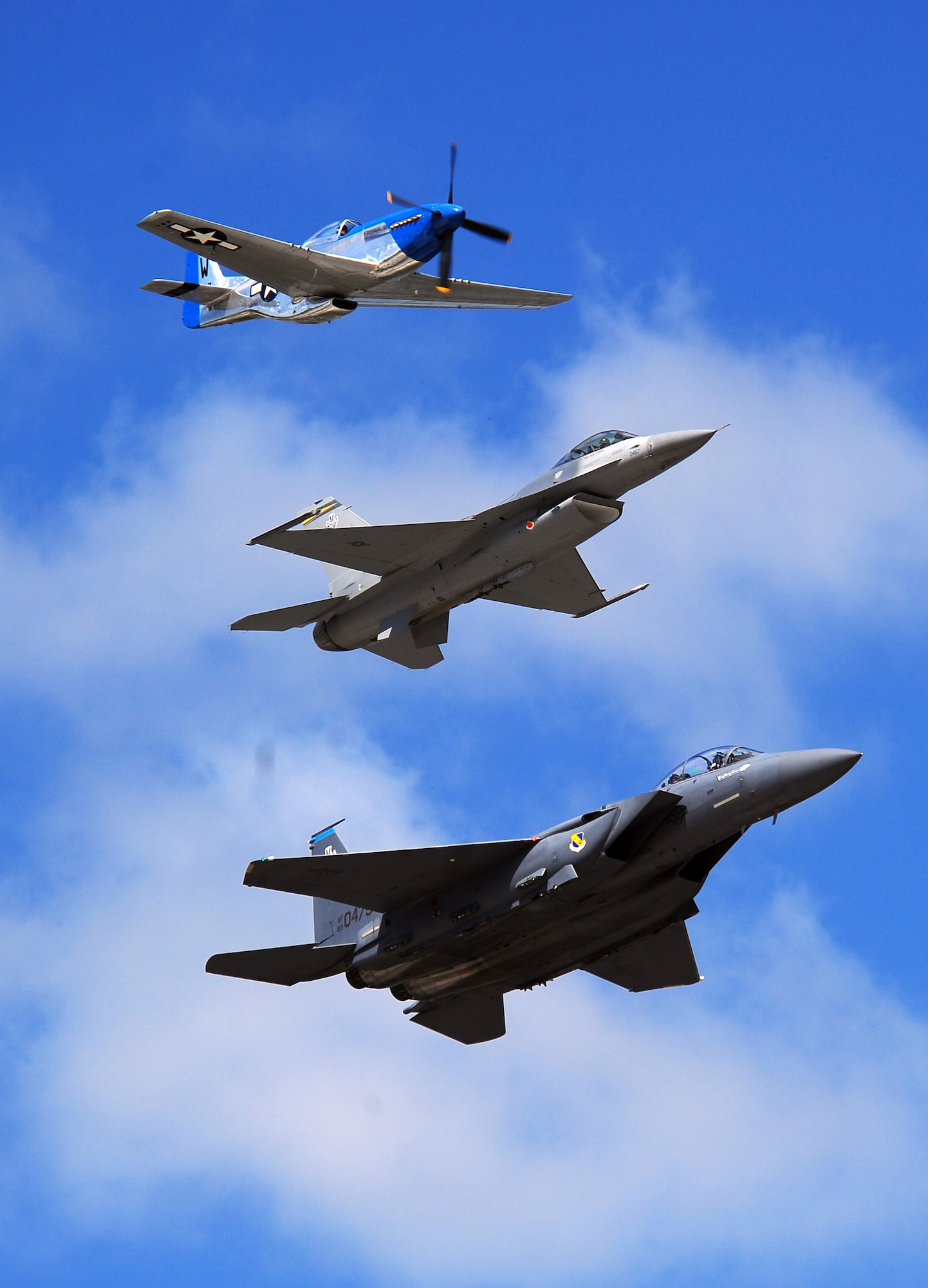 OFFUTT AIR FORCE BASE Neb. -- A P-51 Mustang, an F-16 Fighting Falcon and an F-15 Strike Eagle perform a heritage flight during the 2009 Defenders of Freedom Open House and Air Show here Aug. 29 - 30. The heritage flight honors the aircraft of both the U.S. Army Air Forces and today's Air Force. U.S. Air Force Photo by Josh Plueger