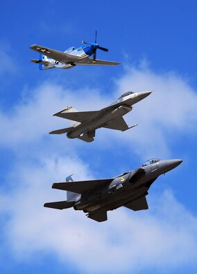 OFFUTT AIR FORCE BASE Neb. -- A P-51 Mustang, an F-16 Fighting Falcon and an F-15 Strike Eagle perform a heritage flight during the 2009 Defenders of Freedom Open House and Air Show here Aug. 29 - 30. The heritage flight honors the aircraft of both the U.S. Army Air Forces and today's Air Force. U.S. Air Force Photo by Josh Plueger