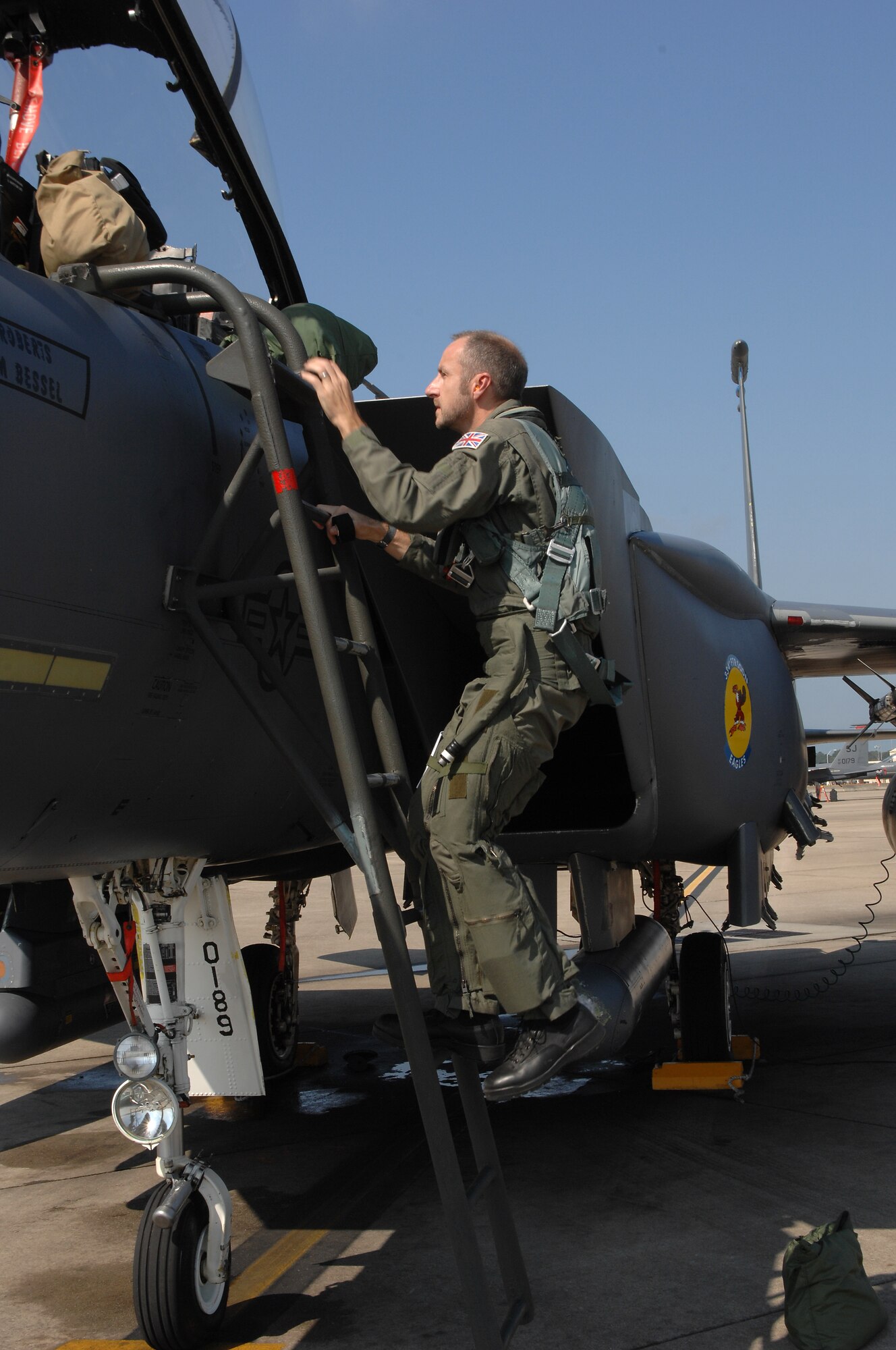 John Dibbs, a free-lance air-to-air photographer, climbs into an F-15E Strike Eagle at Seymour Johnson Air Force Base, N.C., Aug. 26, 2009.  Mr. Dibbs captured photos of F-15E formations for an upcoming issue of Air Forces Monthly and his large coffee table book, “Combat Edge.” (U.S. Air Force photo by Master Sgt. Brandt Smith)