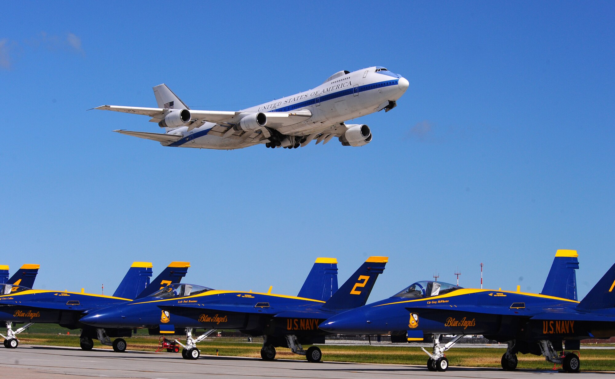 OFFUTT AIR FORCE BASE Neb. -- A Boeing E-4B, an airborne command post, fly's over the U.S. Navy Blue Angels F-18s during the 2009 Defenders of Freedom Open House and Air Show here Aug. 29 - 30. The E-4B serves as the National Airborne Operations Center for the president, secretary of defense and the Joint Chiefs of Staff. In response to an emergency, the aircraft can provide a highly survivable, command, control and communications center to direct U.S. forces, execute emergency war orders and coordinate actions by civil authorities. U.S. Air Force Photo by Josh Plueger