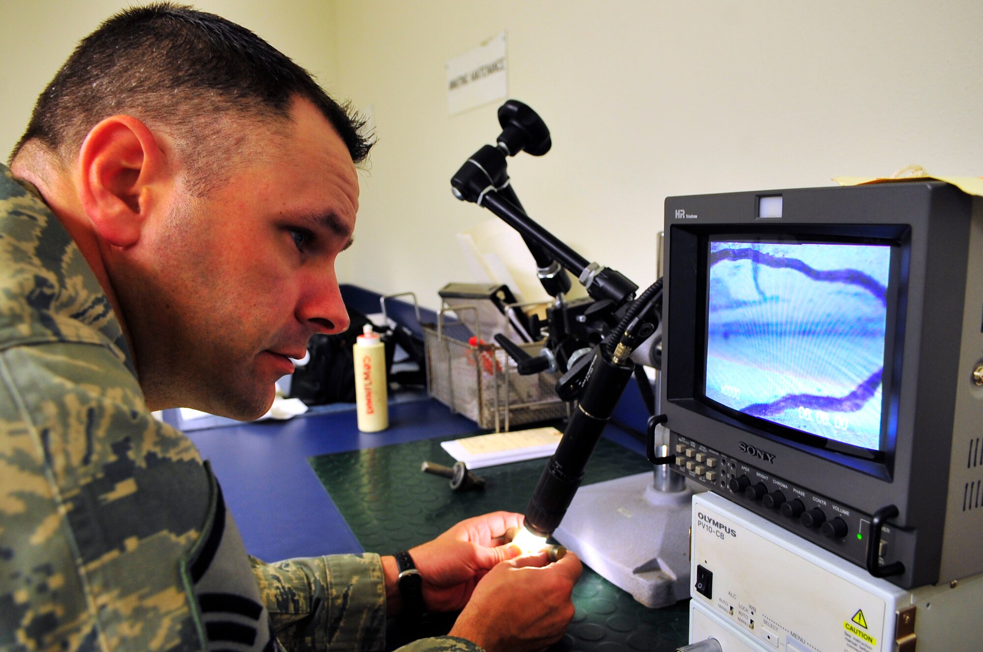 Master Sgt. Mark Hamilton looks at a crack on a bolt through an optical microscope Aug. 26, 2009, Eielson Air Force Base. The optical microscope provides a visual check for surface cracks. Sergeant Hamilton is the non-destructive inspection section chief assigned to the 354th Maintenance Squadron. (U.S. Air Force photo/Staff Sgt. Christopher Boitz)