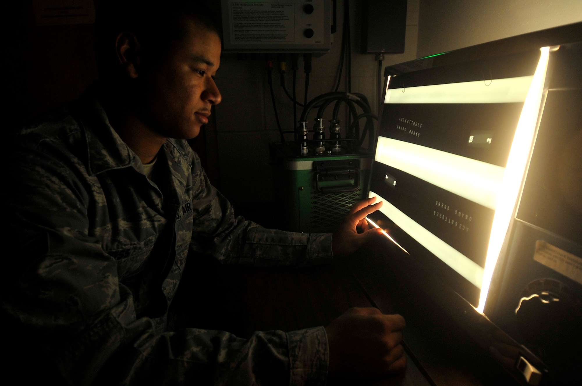 Airman 1st Class Marvin Moss looks at an x-ray of torque tubes from an F-16 for corrosion on Aug. 26, 2009, Eielson Air Force Base. If not detected, the corrosion can lead to defects in the aircraft structure. Airman Moss is a non-destructive inspection journeyman assigned to the 354th Maintenance Squadron. (U.S. Air Force photo/Staff Sgt. Christopher Boitz)