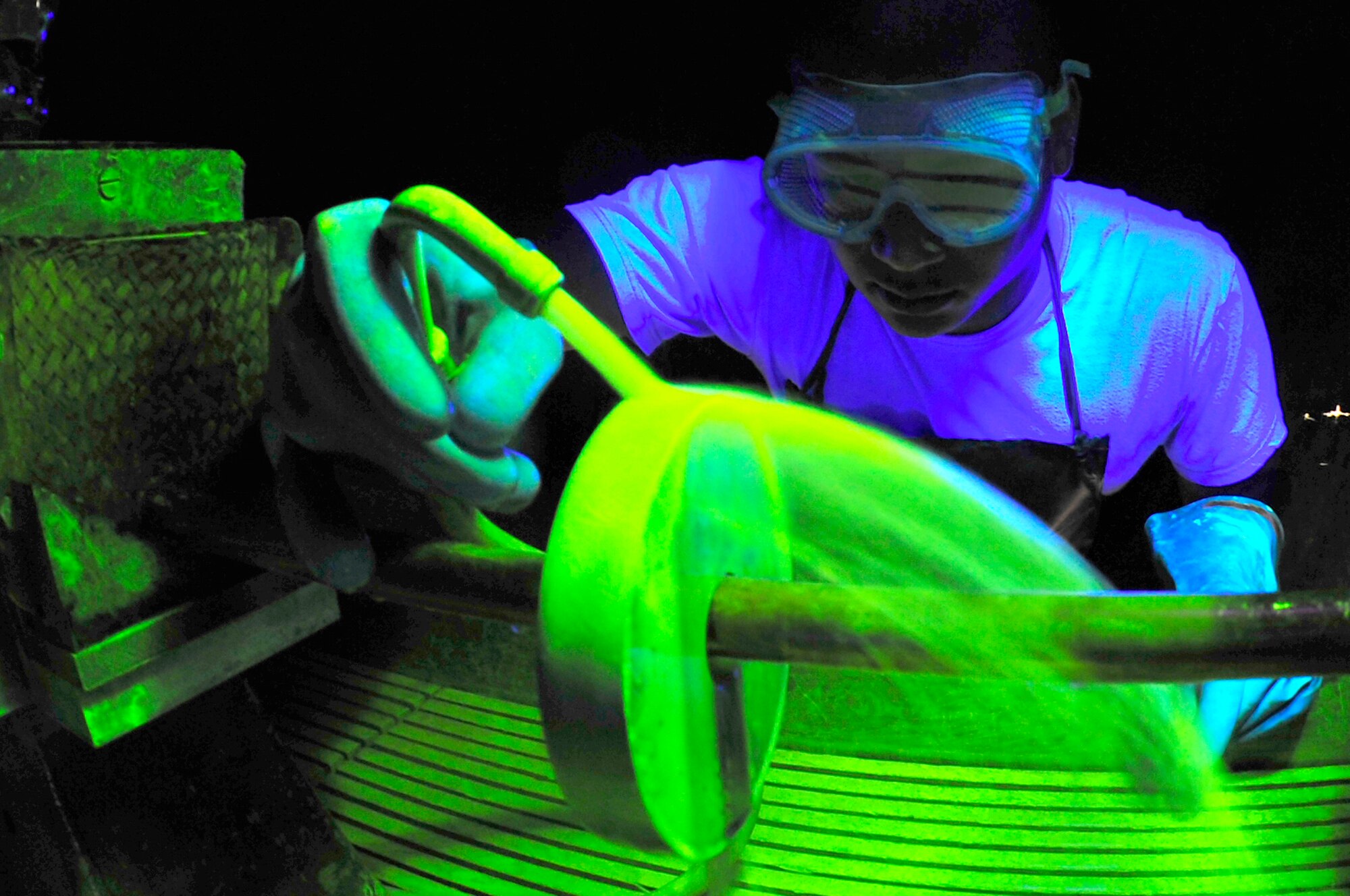 Airman 1st Class Marvin Moss looks for surface defects under a black light Aug. 26, 2009, Eielson Air Force Base. The black light causes particles to become fluorescent which are unseen to the human eye. Airman Moss is a non-destructive inspection journeyman assigned to the 354th Maintenance Squadron. (U.S. Air Force photo/Staff Sgt. Christopher Boitz)

