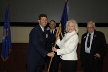 Mrs. Vivian Reeves receives the 927th Air Refueling Wing flag from Colonel Theodore S. Mathews, Jr. during the Honorary Commander's Induction Ceremony (U.S. Air Force Photo/SSgt Joseph Swafford)