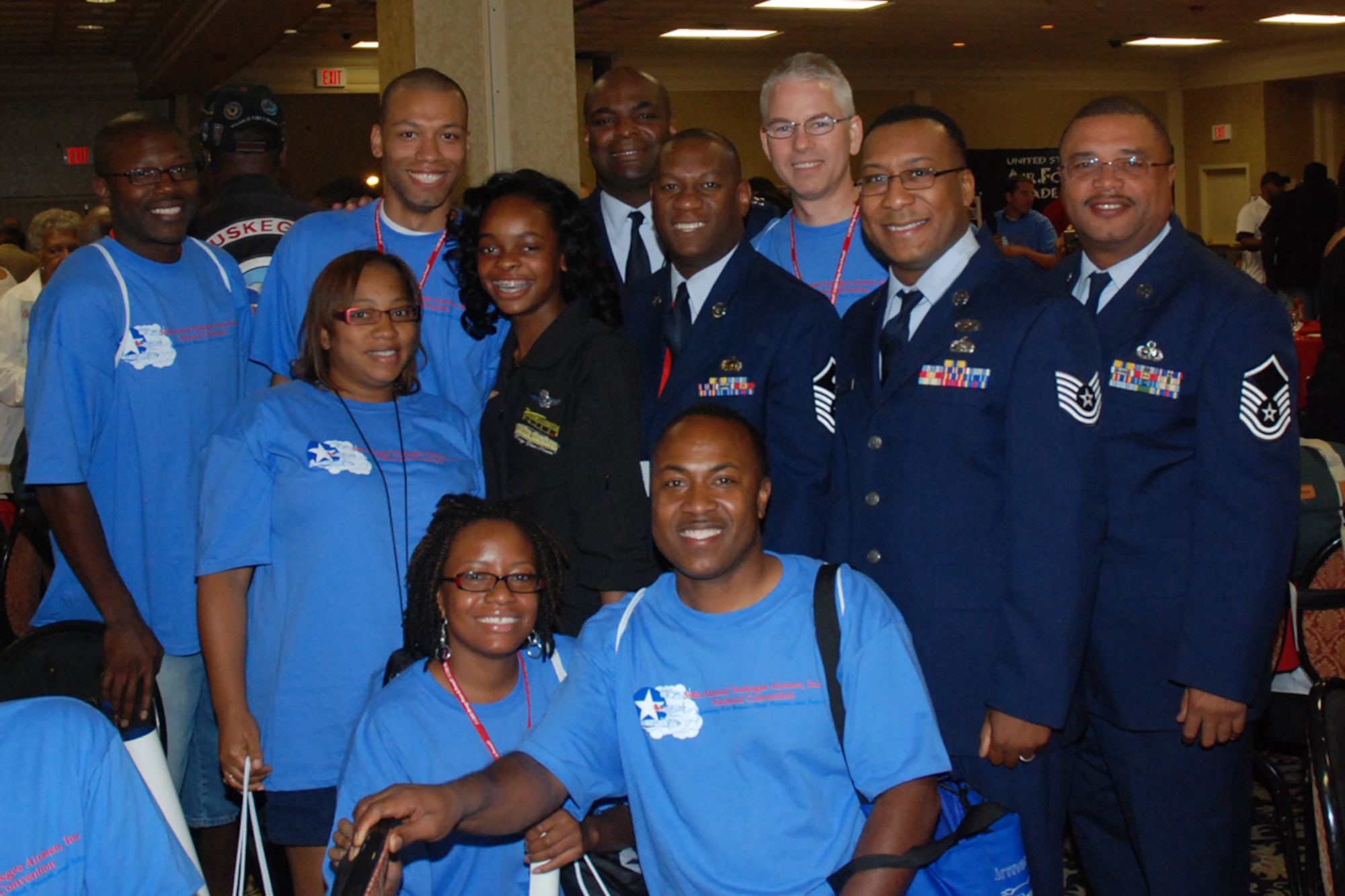 Members of the 94th Airlift Wing meet 15-year-old Kimberly Anyadike (in black) at the 2009 Tuskegee Airman National Convention student luncheon Aug. 8 in Las Vegas, Nev. Kimberly holds the record as the youngest African-American female to fly a plane across the United States solo.