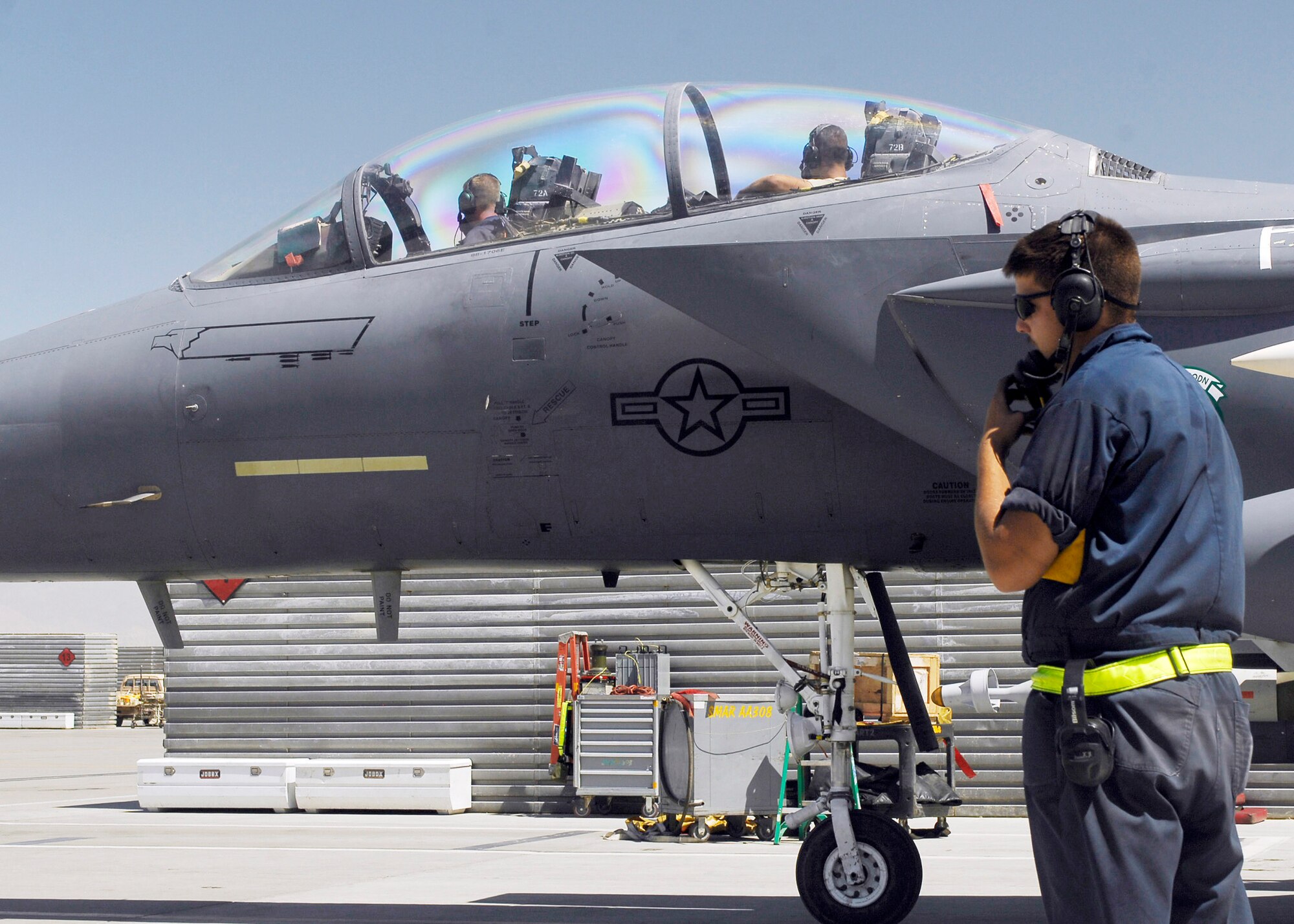 Senior Airman Matthew Jones (front seat) and Staff Sgt. Robert Burton (rear seat) sit in an F-15E Strike Eagle at Bagram Airfield, Afghanistan, during an inspection to check that the flight controls are working properly. During the test, they stay in constant communication with Senior Airman Daniel Scerri (on the ground).  All three Airmen are from the 336th Expeditionary Fighter Squadron and are deployed from Seymour Johnson Air Force Base, N.C.  (U.S. Air Force photo/Senior Airman Felicia Juenke)