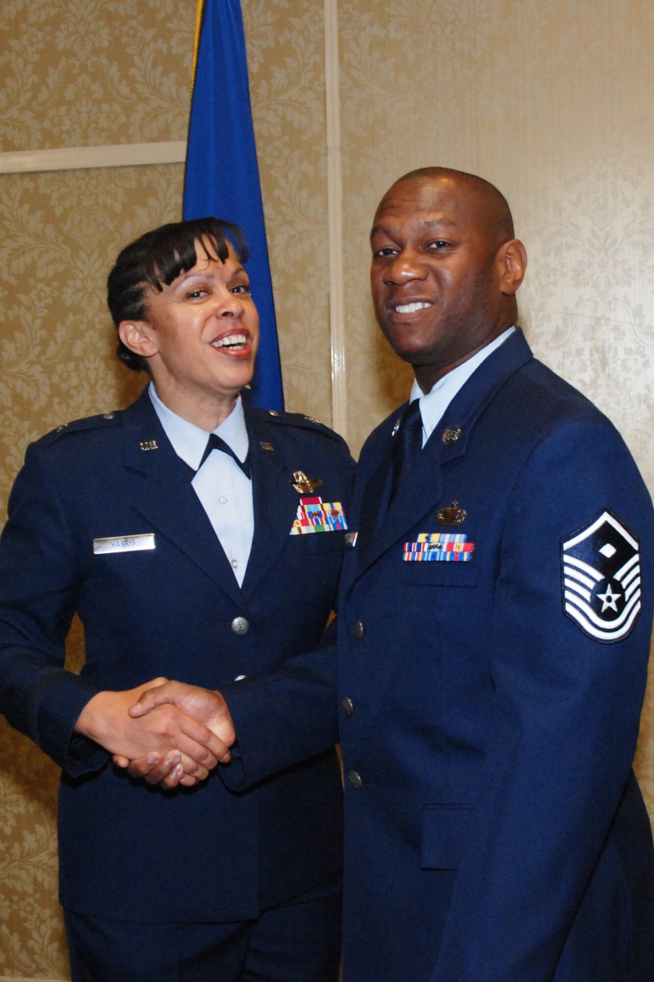Master Sgt. Carl VanDiver, 700th Airlift Squadron first sergeant, congratulates Brig. Gen. Stayce D. Harris during her promotion ceremony at the 2009 Tuskegee Airman National Convention in Las Vegas, Nev., Aug. 8. General Harris is the highest ranking African American female aviator in the Air Force. (U.S. Air Force photo/Tech. Sgt. James Branch)