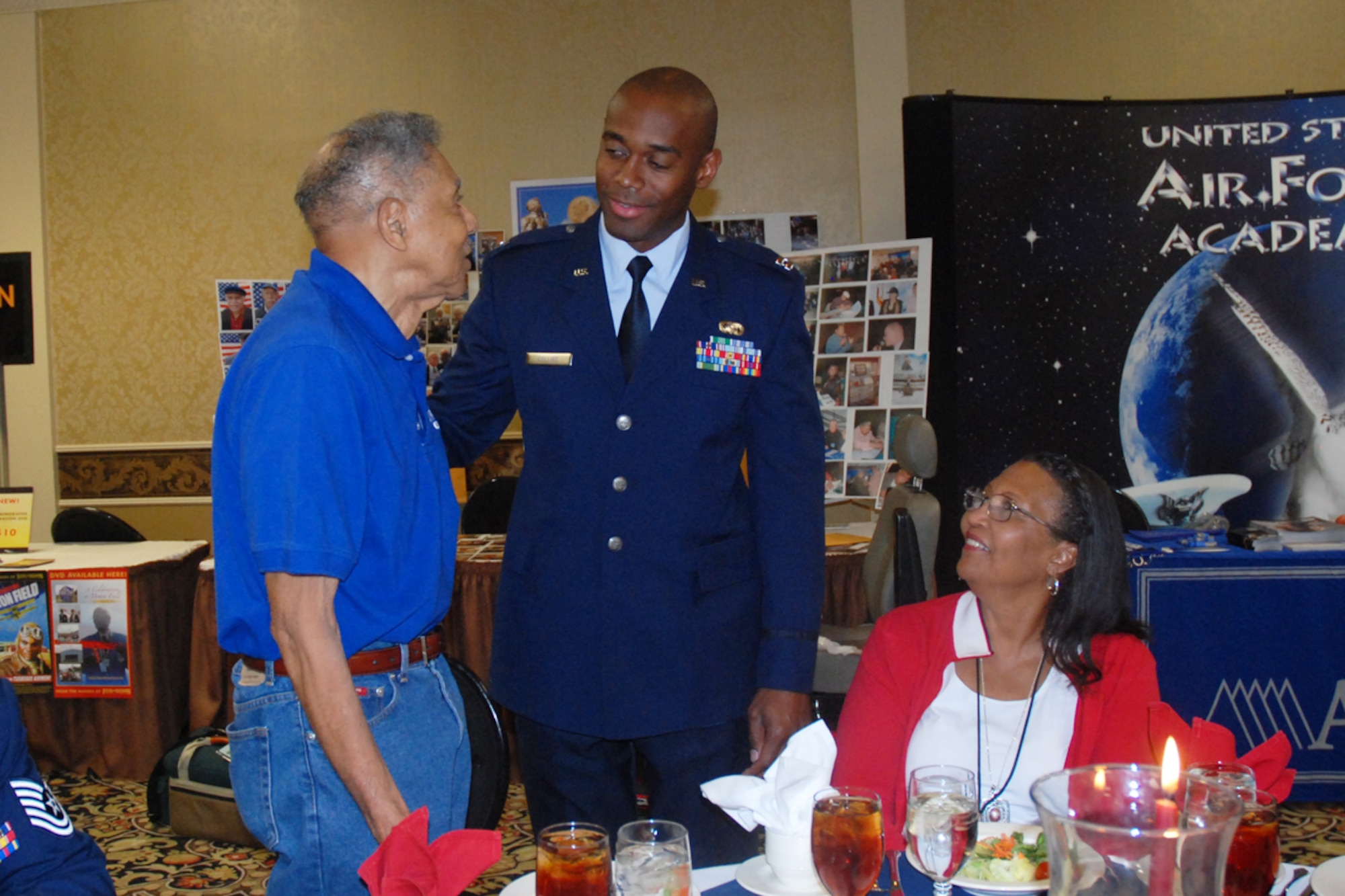 Capt. Toney Collins, 94th Logistics Readiness Squadron, greets Original Tuskegee Airman Boyd Taylor from the Spanky Roberts Tuskegee Airman Chapter in Sacramento, Calif., and his wife Gloria at the 2009 Tuskegee Airman National Convention welcome reception in Las Vegas, Nev. Aug. 7. (U.S. Air Force photo/Tech. Sgt. James Branch)