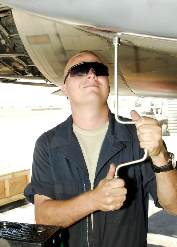 Senior Airman Adam Greene, a crew chief from the 336th Aircraft Maintenance Squadron at Bagram Airfield, Afghanistan, replaces a panel during an inspection of an F-15E Strike Eagle.  Airman Greene is deployed from Seymour Johnson Air Force Base, N.C. Strike Eagles launch around the clock in support of coalition forces.  (U.S. Air Force photo/Senior Airman Felicia Juenke)