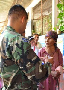 SAN FERNANDO, El Salvador — Aurelia Lopez, 87, receives medicine from a Honduran soldier after seeing an American doctor in the medical readiness and training exercise here Aug. 26. Ms. Lopez walked two hours round-trip to the medical exercise, where she received medical care for the first time in 40 years. A team of personnel from Joint Task Force-Bravo, the Salvadoran military and the Salvadoran Ministry of Health worked together during the two-day medical exercise to provide free medical care to more than 900 patients (U.S. Air Force photo/1st Lt. Jennifer Richard).